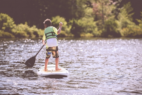 boy stand up paddle board